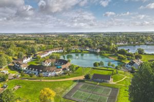 Aerial view of lodge, tennis courts and lake- click for photo gallery